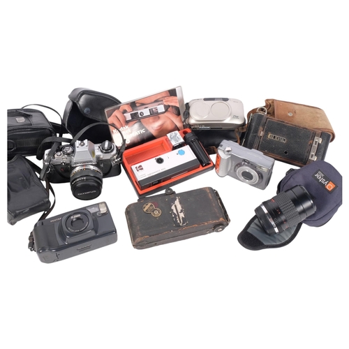 309 - A quantity of Vintage cameras, including an Olympus OM10, an Ensign Carbine folding camera, a Canon ... 