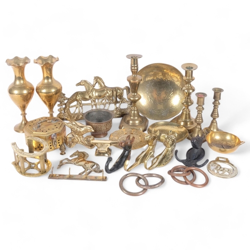 61 - A quantity of brassware, including various candlesticks, vases, etc