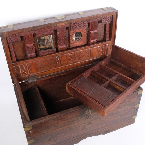 73 - An Anglo-Indian teak travelling box, the rising lid revealing a lift-out fitted interior, mirrored l... 