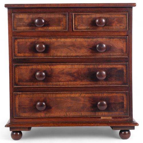 79 - A 19th century mahogany table-top chest, with 2 short and 3 long crossbanded drawers, with turned wo... 