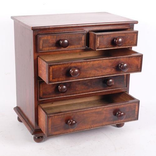 79 - A 19th century mahogany table-top chest, with 2 short and 3 long crossbanded drawers, with turned wo... 