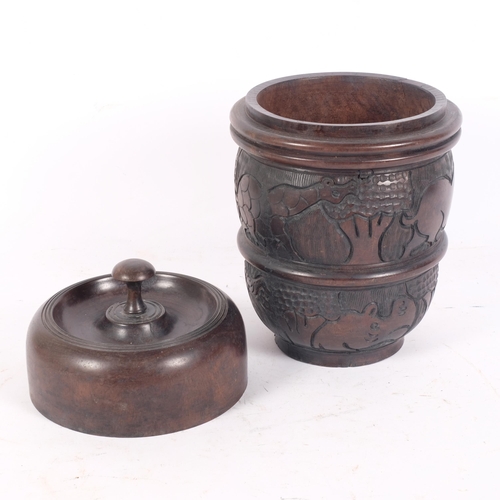 85 - An African turned hardwood cylindrical box and cover, with engraved animal decoration, H31cm