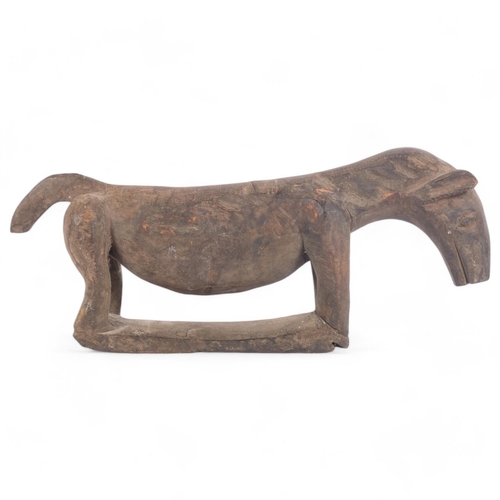 86 - A carved African head rest in the form of an aardvark, L46cm