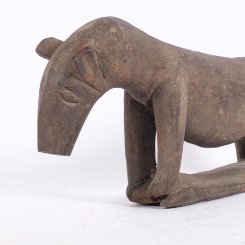 86 - A carved African head rest in the form of an aardvark, L46cm