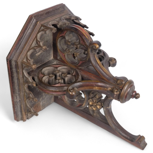 88 - A large Victorian Ecclesiastical oak and partial gilded and stained wall bracket, with carved and pi... 