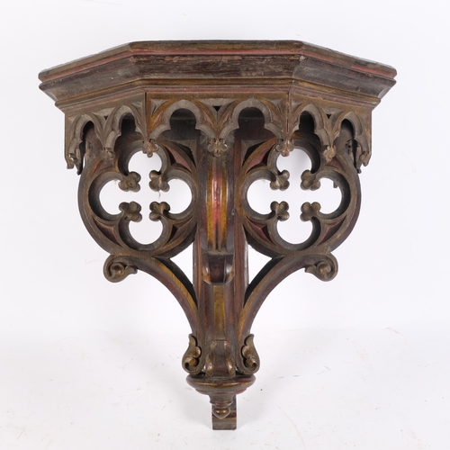 88 - A large Victorian Ecclesiastical oak and partial gilded and stained wall bracket, with carved and pi... 