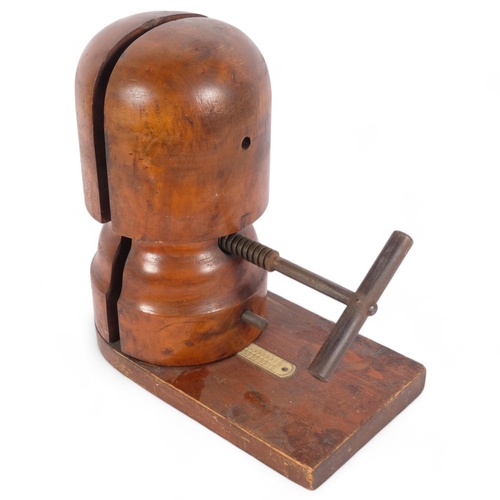 90 - An early 20th century hat stretcher on rectangular stand, with plastic scale, H33cm