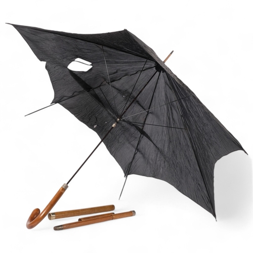 93 - A sectional turned walking stick with single silver mount concealing an umbrella