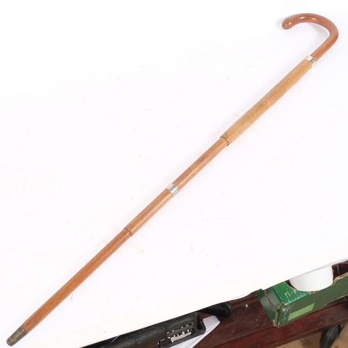 93 - A sectional turned walking stick with single silver mount concealing an umbrella