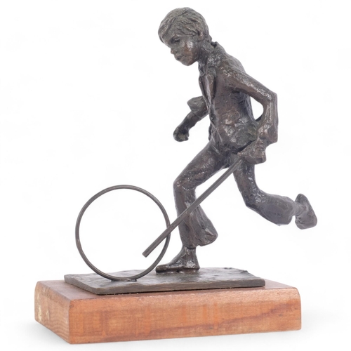 94 - Jill Cowie Sanders, patinated bronze sculpture of a boy with a hoop and stick, on stand, signed to t... 