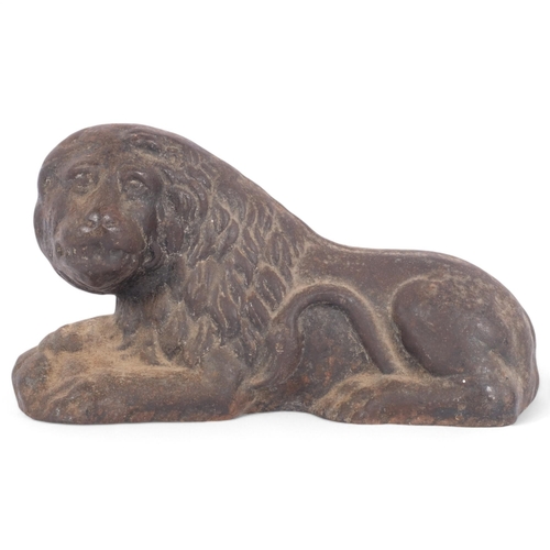 95 - A cast-iron sculpture of a recumbent lion, L23cm