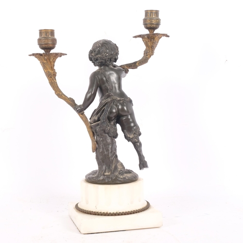 98 - After Clodin, a patinated bronze and gilt-brass 2-branch candelabra, modelled as a faun, mounted on ... 