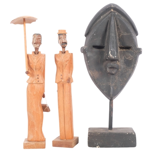 428 - 2 x 1940s Cuban stylised wood figures, and an African plaster mask sculpture on stand, H35cm (3)