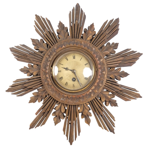 432 - A Vintage carved wood sunburst wall clock, unmarked, diameter approx 42cm