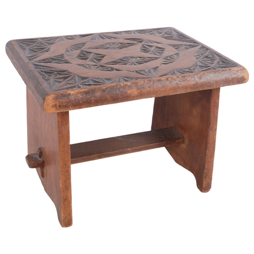 448 - A small chip carved oak stool, H22cm, W30cm, D23cm