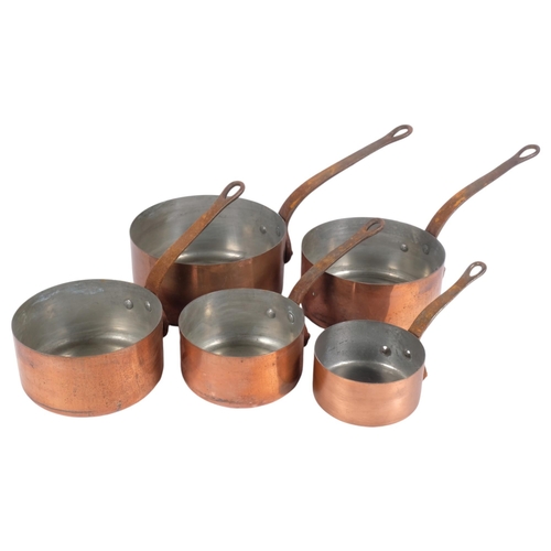 460 - A graduated set of French copper saucepans, each with a cast-iron handle, unmarked, largest diameter... 