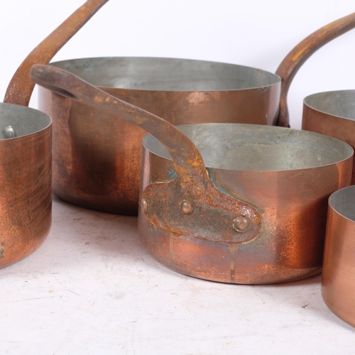 460 - A graduated set of French copper saucepans, each with a cast-iron handle, unmarked, largest diameter... 