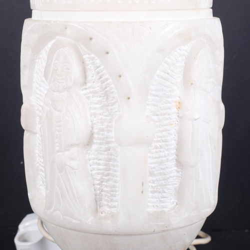 469 - A relief carved alabaster table lamp, with Gothic figural carving to centre, with associated shade, ... 