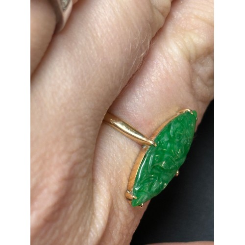 1144 - A Chinese 18ct gold jade panel ring, maker WH, set with carved marquise cabochon jade depicting bird... 