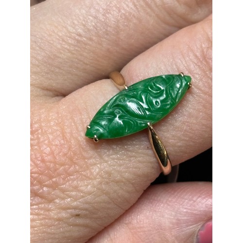 1144 - A Chinese 18ct gold jade panel ring, maker WH, set with carved marquise cabochon jade depicting bird... 