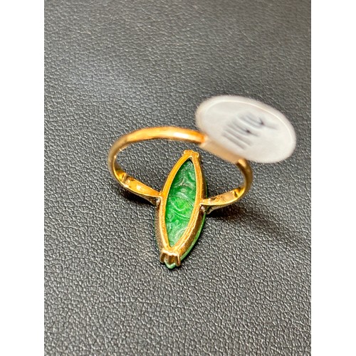 1144 - A Chinese 18ct gold jade panel ring, maker WH, set with carved marquise cabochon jade depicting bird... 