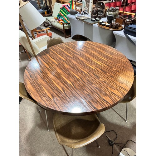 506 - A 1970s' dining table by GORDON RUSSELL, with polished chrome frame, height 73cm, diameter 137cm