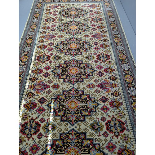 2325 - A modern Saudi Arabian part silk cream ground Persian design carpet. Length 388cm, width 187cm.