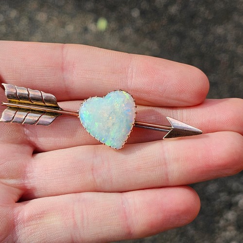 1100 - A large Antique 9ct rose gold opal 'Heart and Arrow' brooch, maker G&SA, set with heart cabochon whi... 