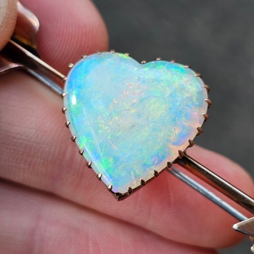 1100 - A large Antique 9ct rose gold opal 'Heart and Arrow' brooch, maker G&SA, set with heart cabochon whi... 