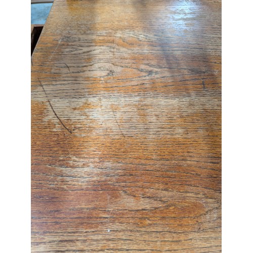 2560 - A 1930s oak dining table, with end frieze drawer and raised on tapered legs. Length 175cm, height 76... 