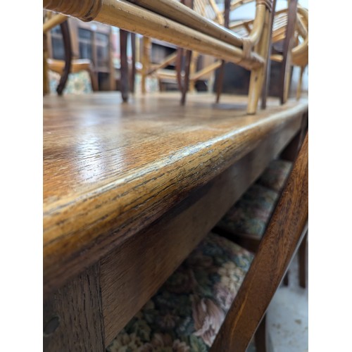 2560 - A 1930s oak dining table, with end frieze drawer and raised on tapered legs. Length 175cm, height 76... 