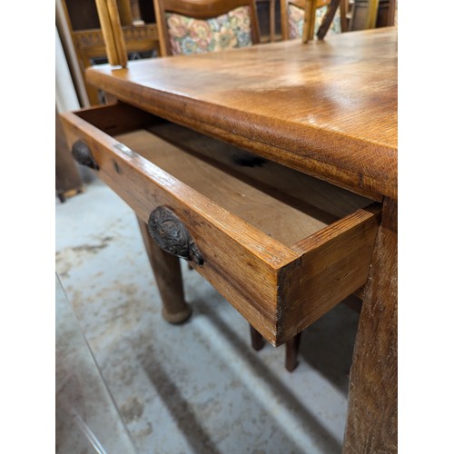 2560 - A 1930s oak dining table, with end frieze drawer and raised on tapered legs. Length 175cm, height 76... 