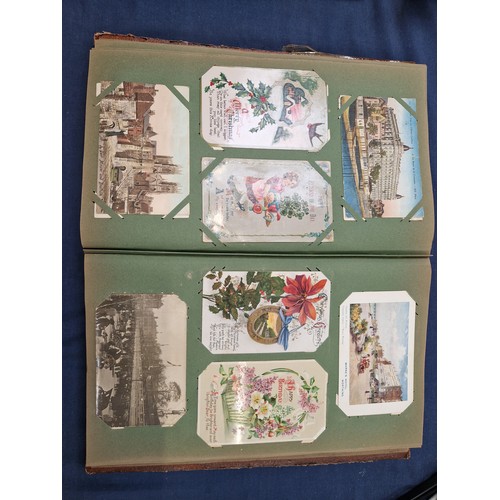 165 - A mixed album of Vintage postcards, including military, family, topographical and greetings cards