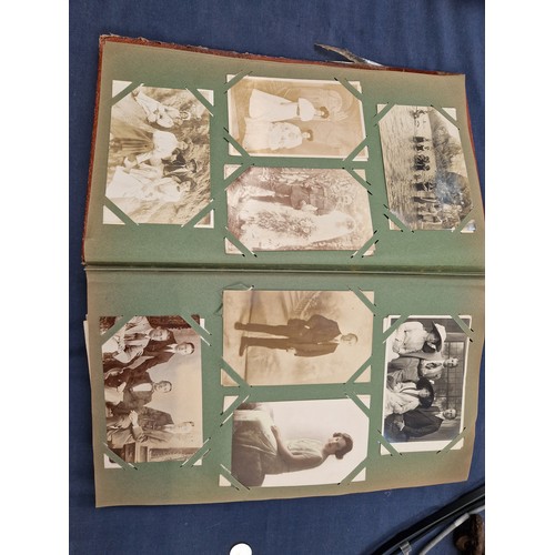 165 - A mixed album of Vintage postcards, including military, family, topographical and greetings cards