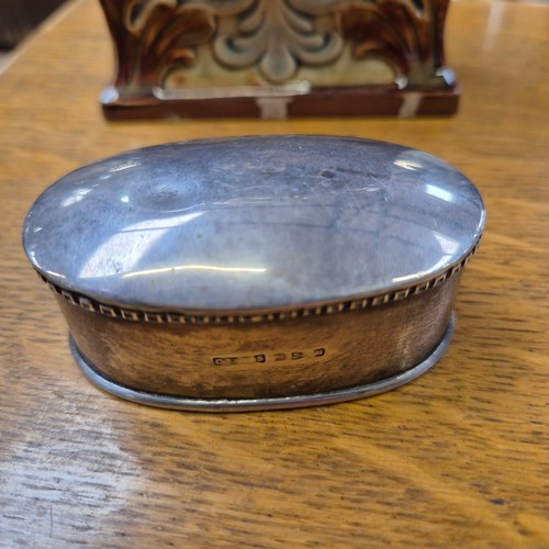 217 - A late Victorian Doulton Lambeth silver-mounted stoneware pottery tea caddy, of rectangular waisted ... 