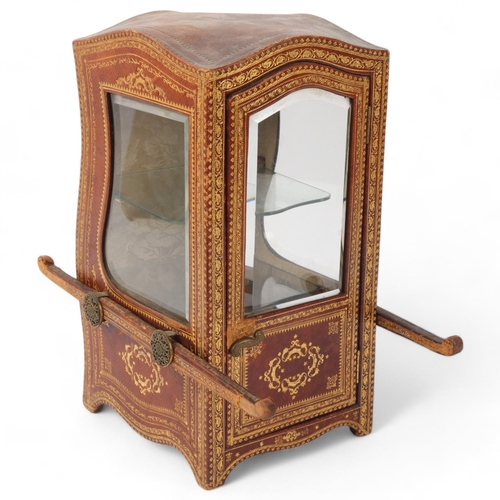 1 - A small desk-top vitrine cabinet in the form of a sedan chair, gilded leather-covered with shaped be... 