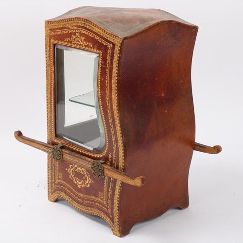 1 - A small desk-top vitrine cabinet in the form of a sedan chair, gilded leather-covered with shaped be... 