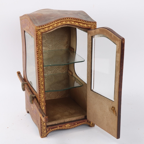 1 - A small desk-top vitrine cabinet in the form of a sedan chair, gilded leather-covered with shaped be... 