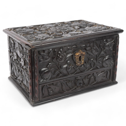 14 - An early 19th century Sri Lankan ebony box, circa 1830, relief carved allover with hinged lid and dr... 