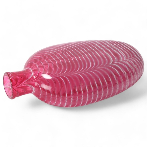 32 - A 19th century hand-blown cranberry glass flask with trailed white decoration, length 19cm