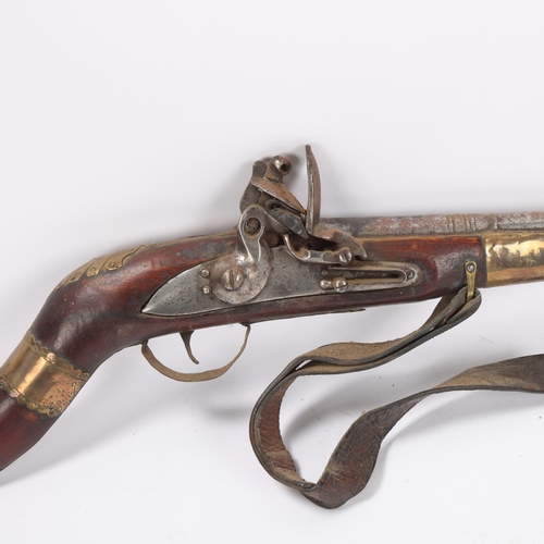 37 - Antique Indian flintlock rifle, overall length 128cm