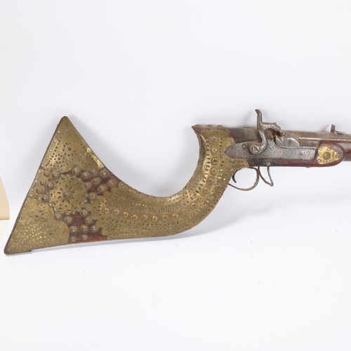 38 - Antique Indian flintlock rifle, pierced brass-mounted stock, overall length 122cm