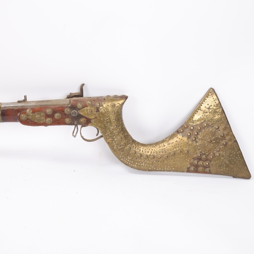 38 - Antique Indian flintlock rifle, pierced brass-mounted stock, overall length 122cm