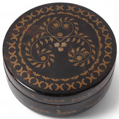 57 - 19th century circular tortoiseshell box, with inlaid geometric designs, diameter 8cm