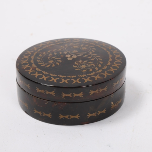 57 - 19th century circular tortoiseshell box, with inlaid geometric designs, diameter 8cm