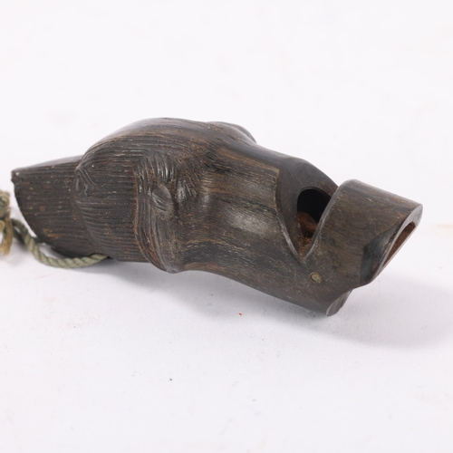 68 - A 19th century carved horn dog's head design whistle, length 6.5cm