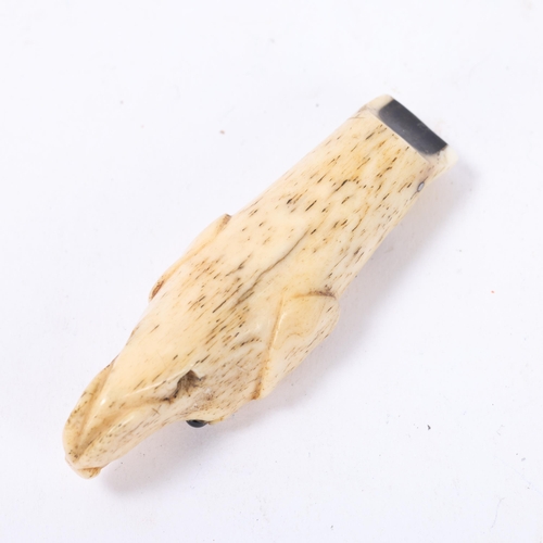 69 - A 19th century carved bone dog's head design whistle with glass eyes, length 68mm