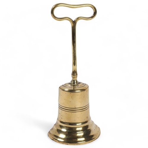 129 - An 18th century brass and lead weighted half-bell design doorstop, height 26cm