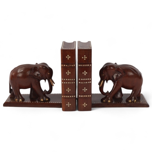 130 - A pair of Ceylonese early 20th century hardwood elephant design puzzle bookends, with secret compart... 