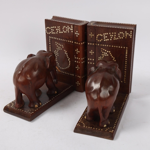 130 - A pair of Ceylonese early 20th century hardwood elephant design puzzle bookends, with secret compart... 